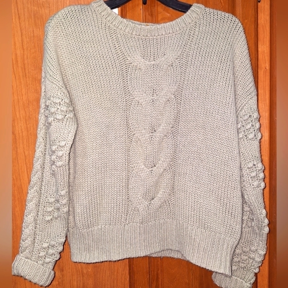 A Moon and Madison ladies chunky cable knit sweater in a size small.